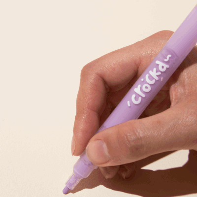 Demonstration of purple acrylic paint marker on a surface